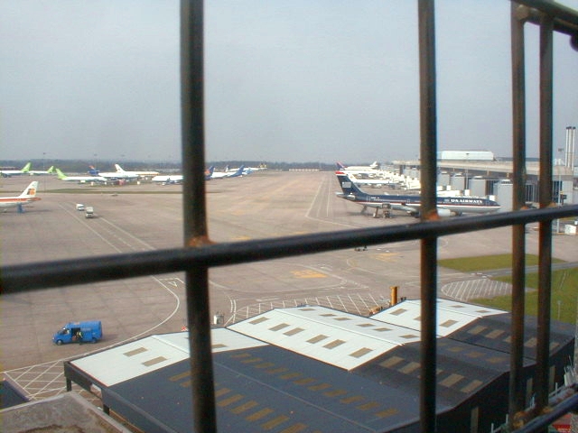 Plane spotters watching aircraft from the perimeter fence at Manchester Airport